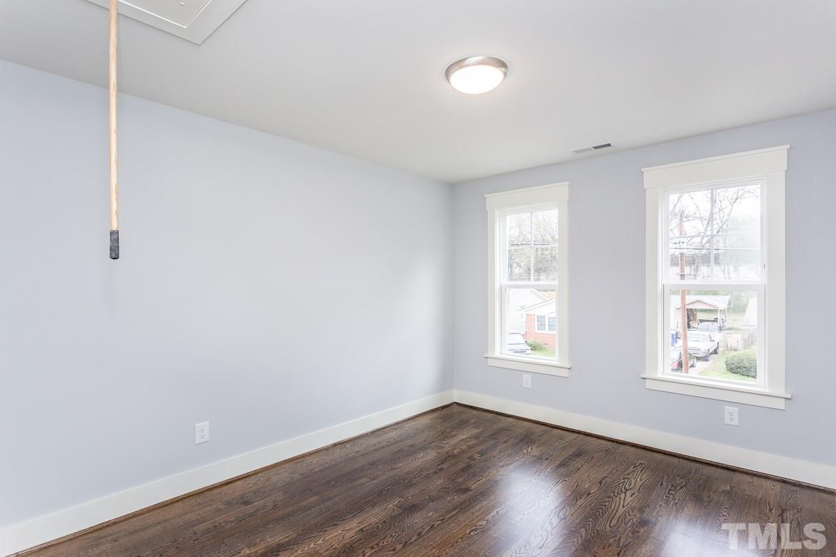 830 Coleman Street Raleigh, NC 27610 - Photo 19 of 24 an empty room with wooden floor and windows