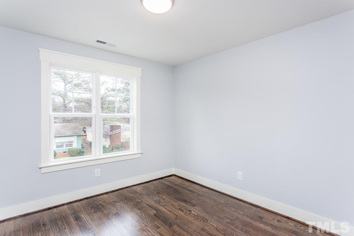 830 Coleman Street Raleigh, NC 27610 - Photo 20 of 24 an empty room with wooden floor and windows