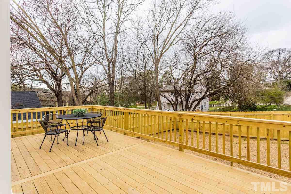 830 Coleman Street Raleigh, NC 27610 - Photo 22 of 24 a view of a patio with table and chairs and wooden floor