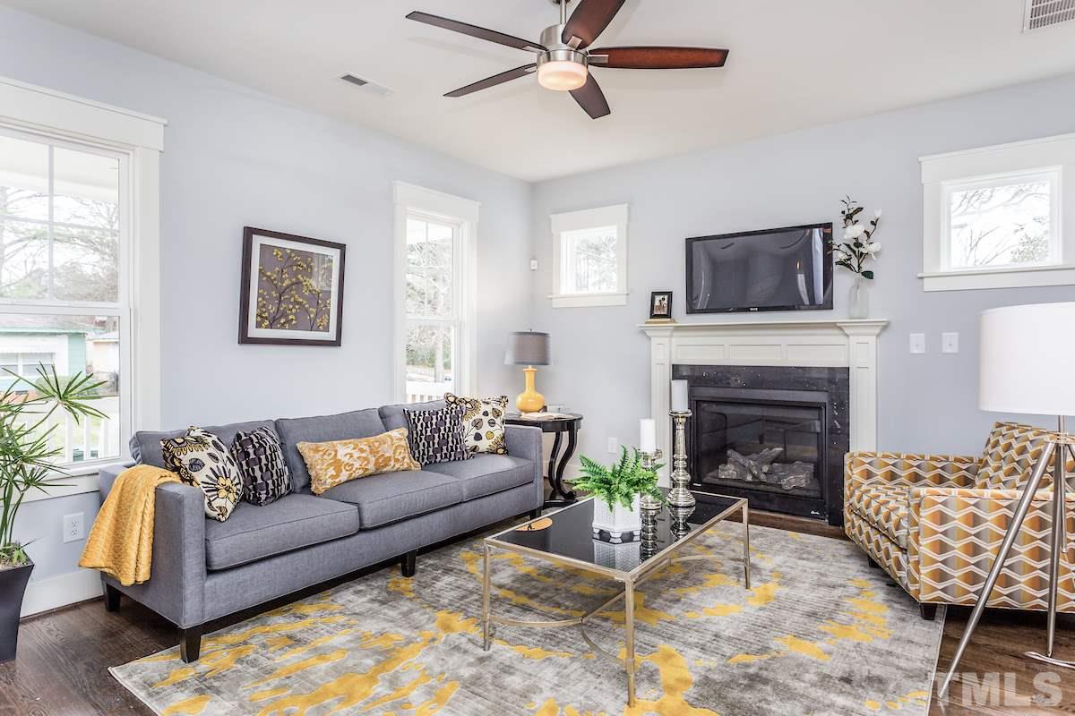 830 Coleman Street Raleigh, NC 27610 - Photo 4 of 24 a living room with furniture and a fireplace