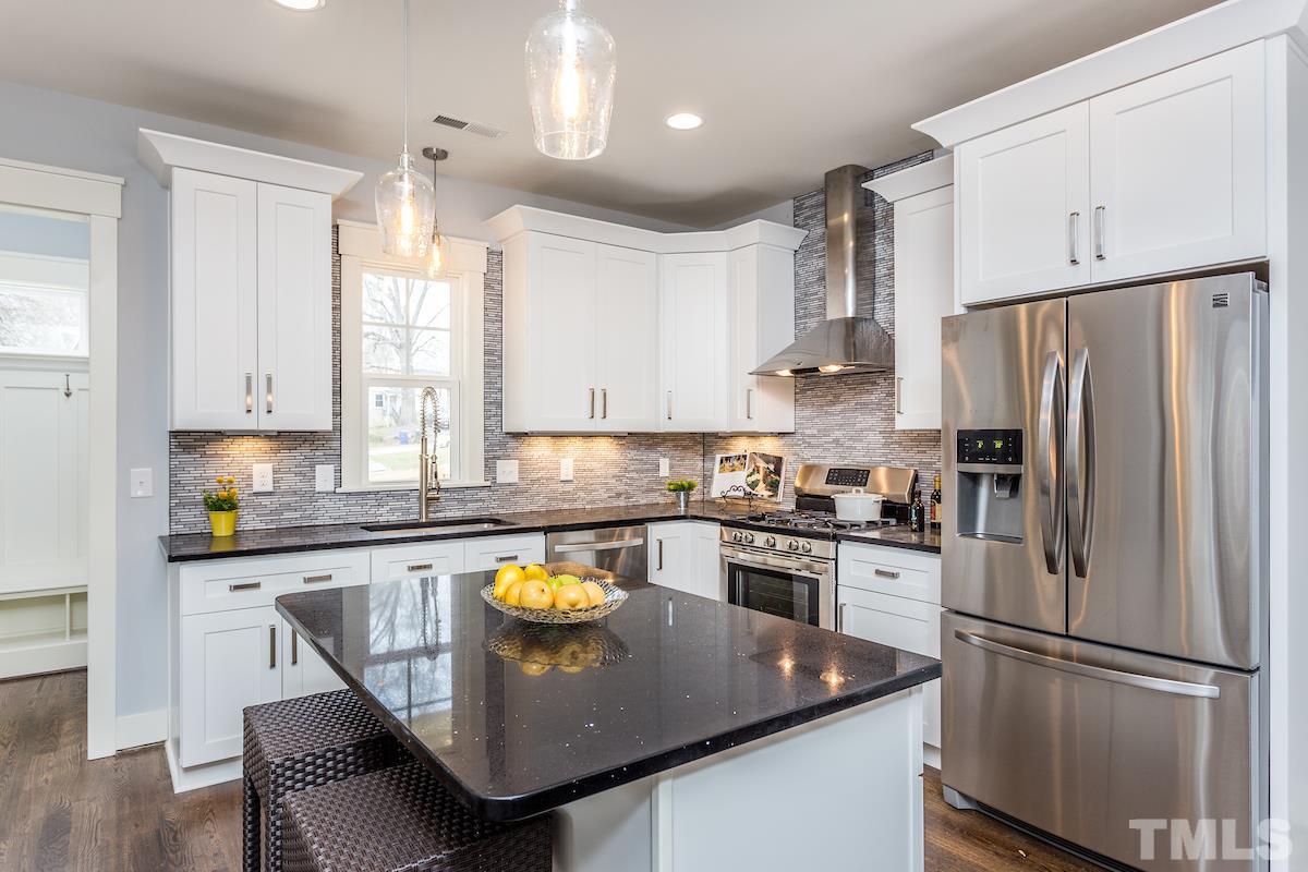 830 Coleman Street Raleigh, NC 27610 - Photo 9 of 24 a kitchen with stainless steel appliances granite countertop a sink a stove a refrigerator and white cabinets