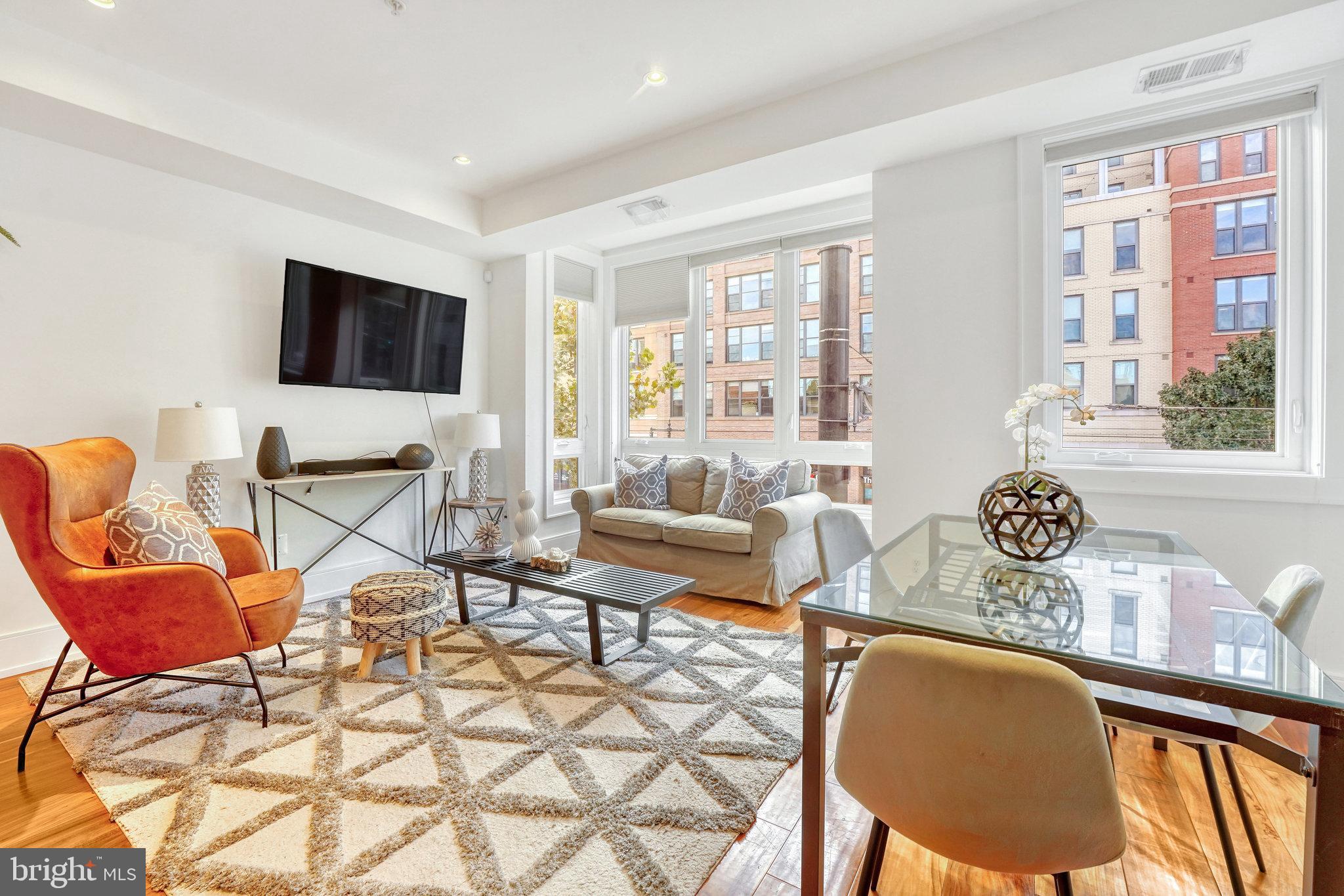 904 H Street Northeast, Unit 1 Washington, DC 20002 - Photo 1 of 17 a living room with furniture and a flat screen tv