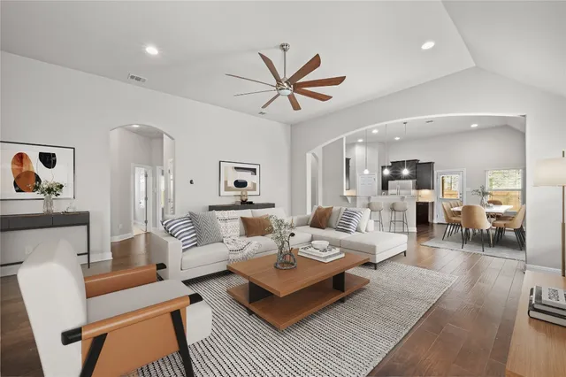 a living room with furniture and wooden floor