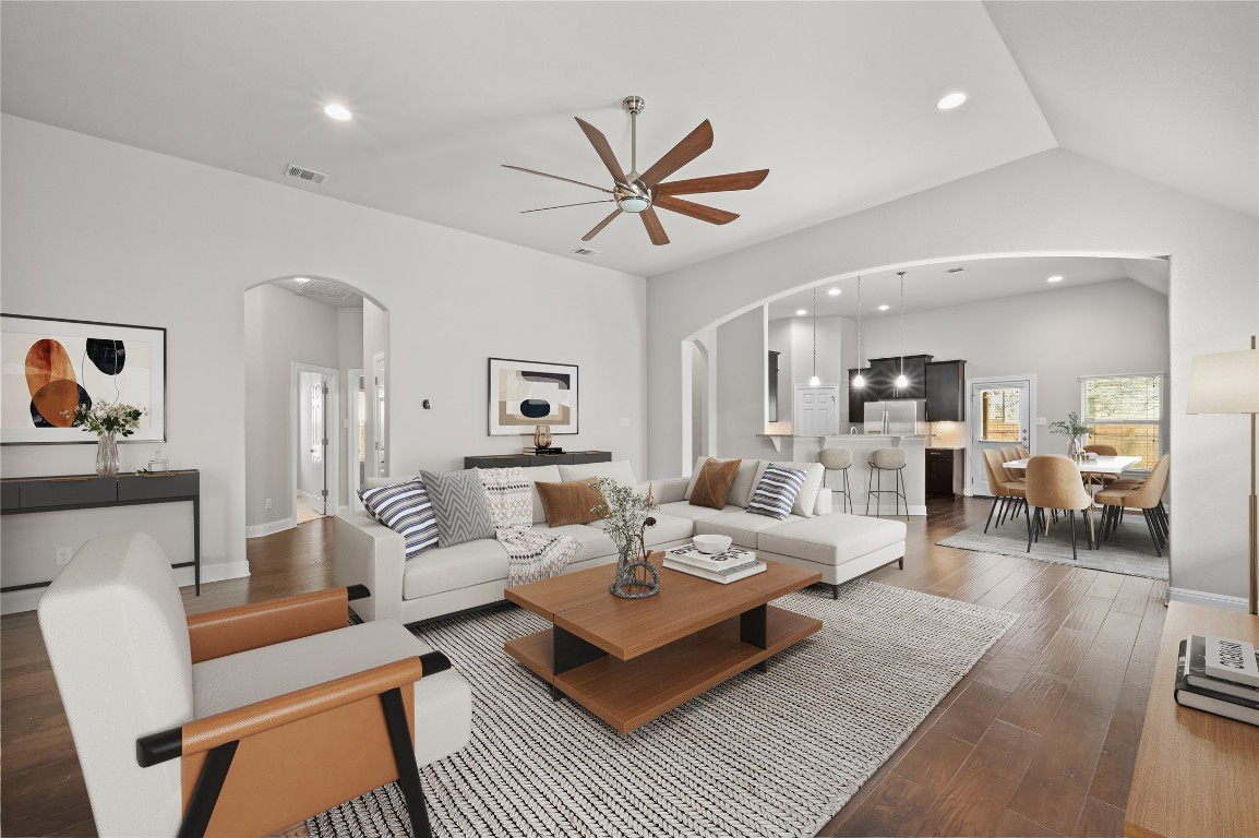 a living room with furniture and wooden floor