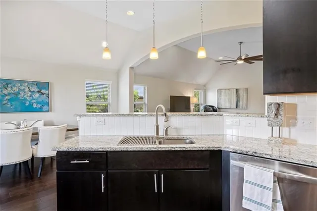 a kitchen with center island a sink stainless steel appliances and window