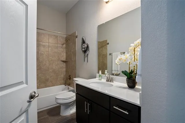a bathroom with a double vanity sink toilet and shower