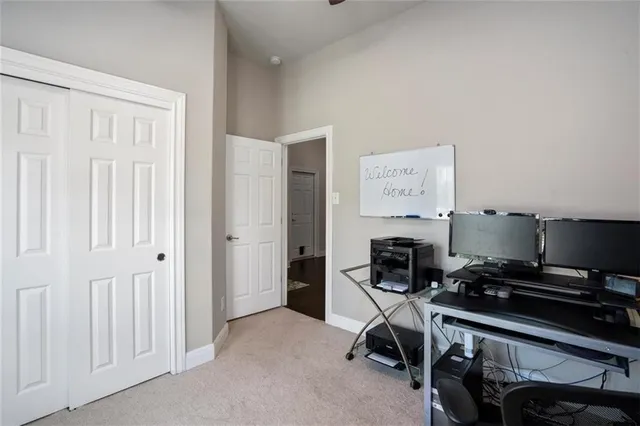 a view of a workspace with furniture and a window