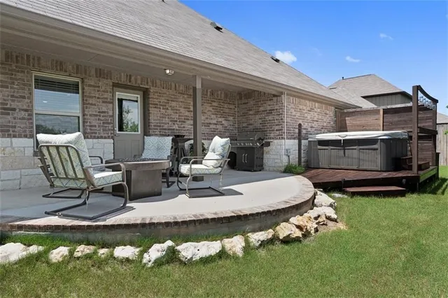 a view of a patio with table and chairs and potted plants