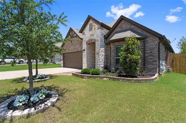 a front view of a house with garden
