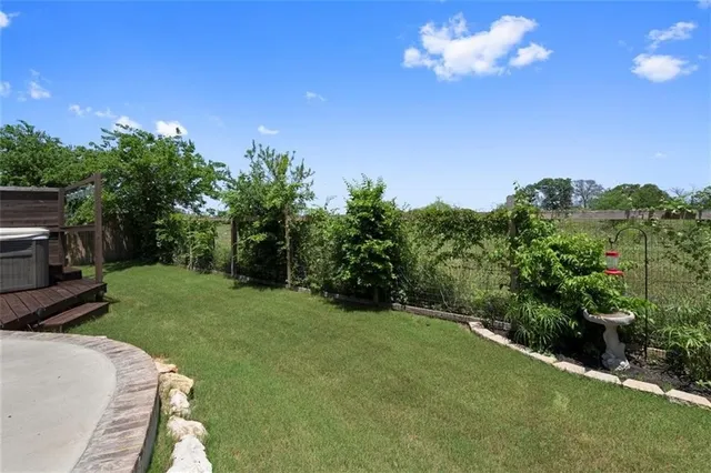 a view of a yard with an outdoor space and deck