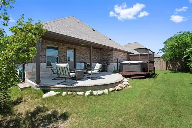 a view of a house with backyard porch and sitting area