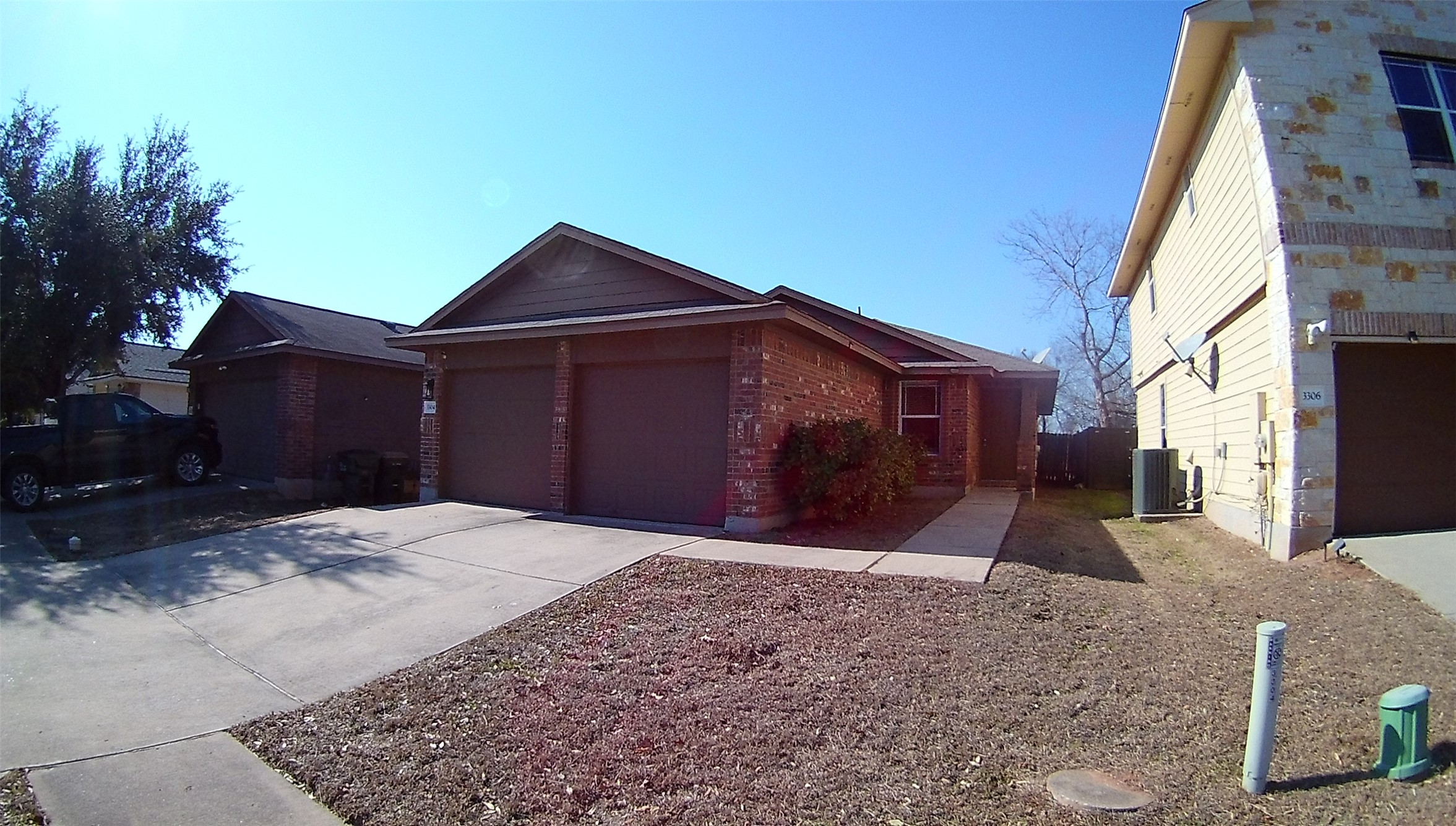 3304 Wickham Lane Austin, TX 78725 - Photo 1 of 13 Ranch-style home with concrete driveway, brick siding, and an attached garage