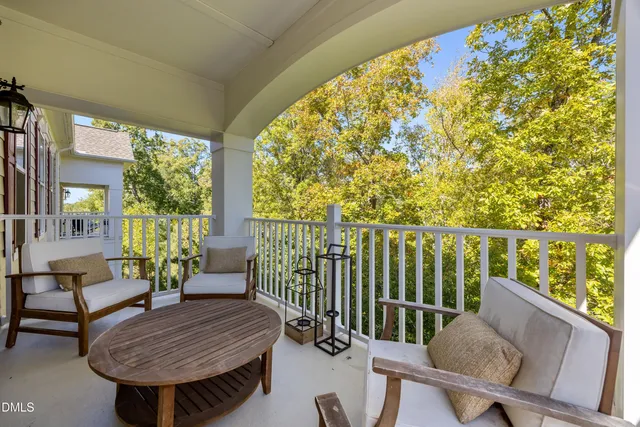 a kitchen with stainless steel appliances granite countertop a stove a sink a refrigerator and white cabinets