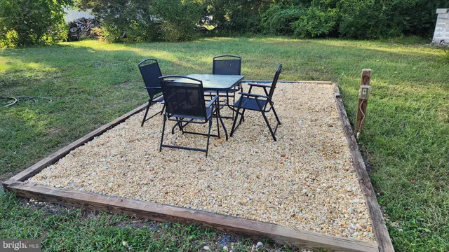 a view of a chairs and table in the garden