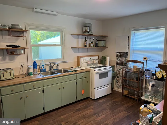 a kitchen with appliances a sink and a window