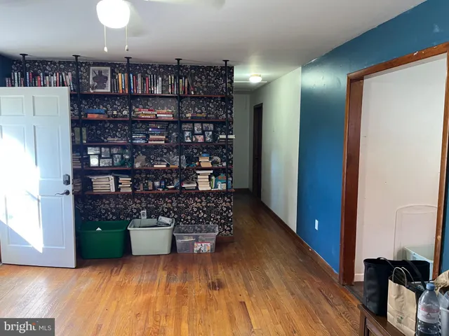 a room with lots of books and a large window