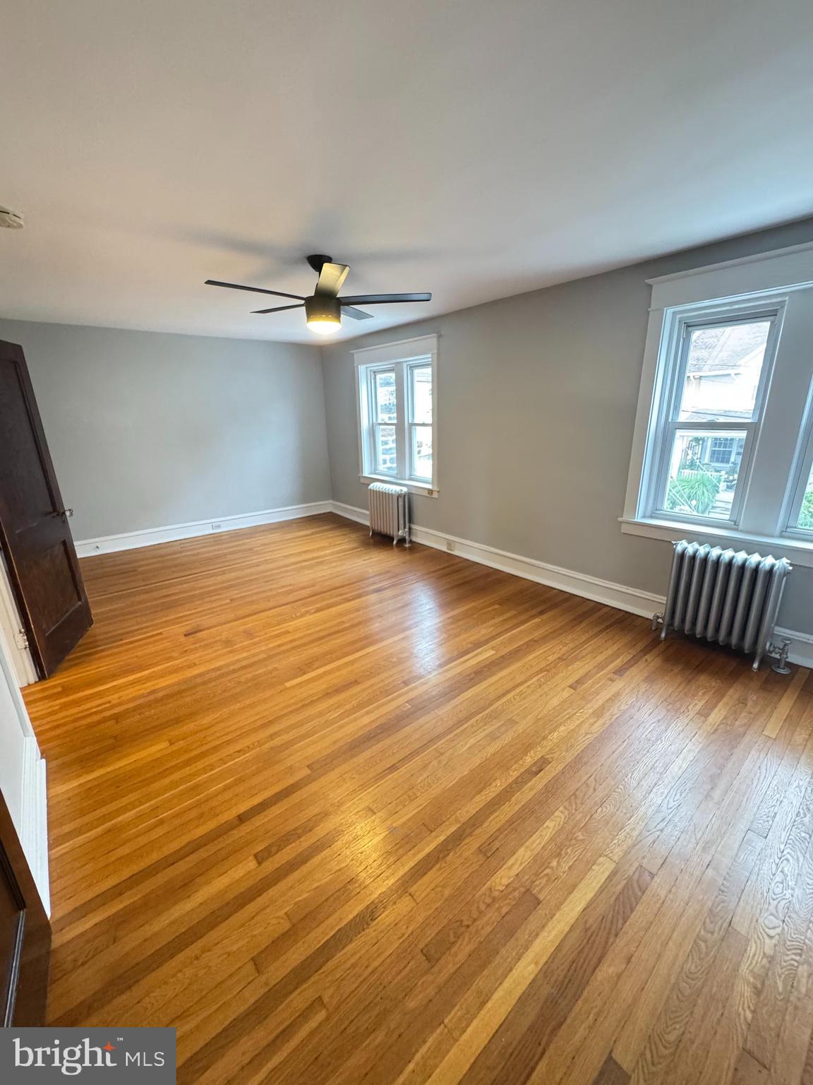 12 West Athens Avenue Ardmore, PA 19003 - Photo 12 of 18 an empty room with wooden floor and windows