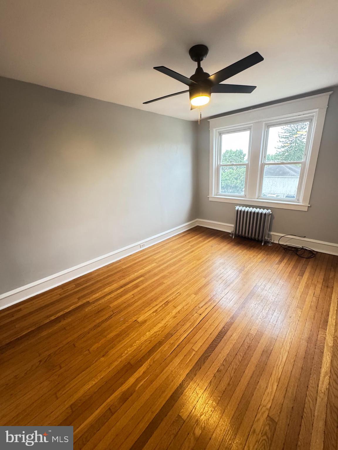12 West Athens Avenue Ardmore, PA 19003 - Photo 15 of 18 a view of an empty room with wooden floor and a window