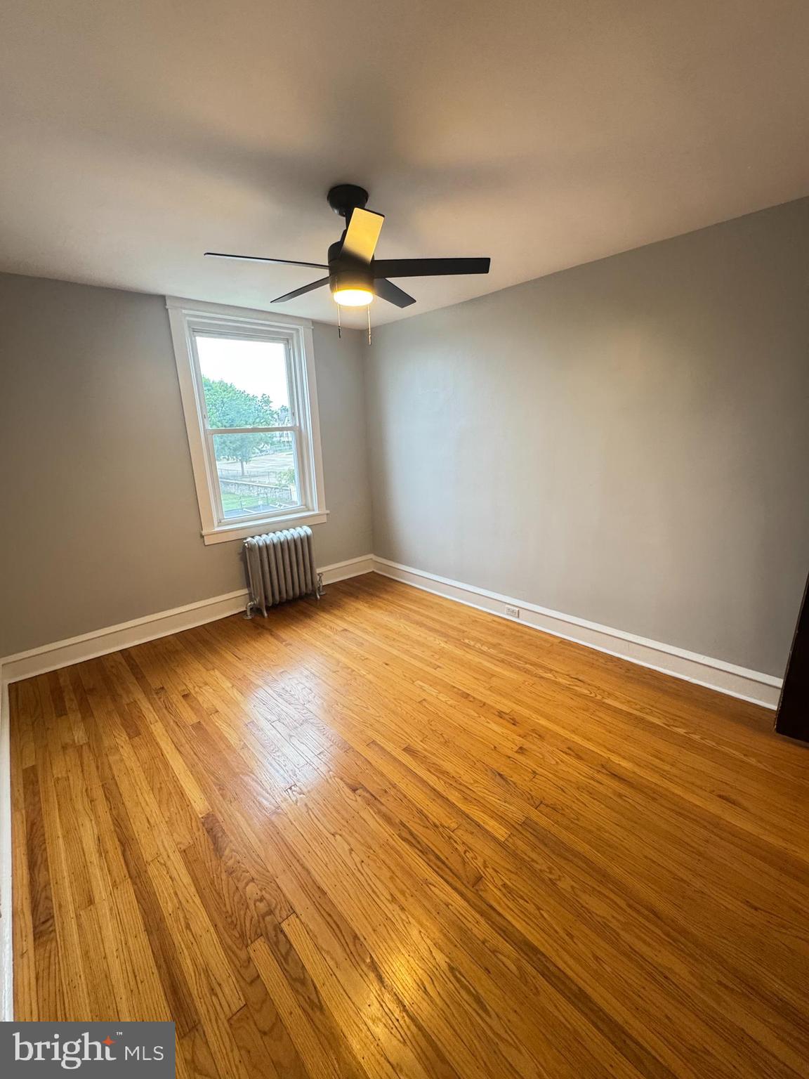 12 West Athens Avenue Ardmore, PA 19003 - Photo 16 of 18 a view of an empty room with wooden floor and a window