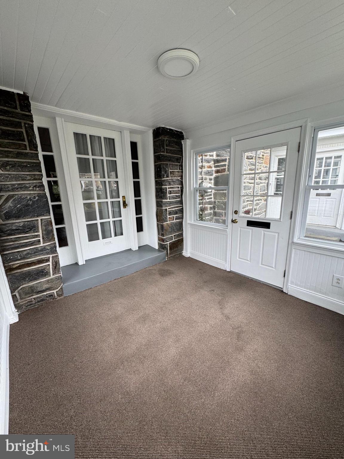 12 West Athens Avenue Ardmore, PA 19003 - Photo 2 of 18 an empty room with a fireplace and large window