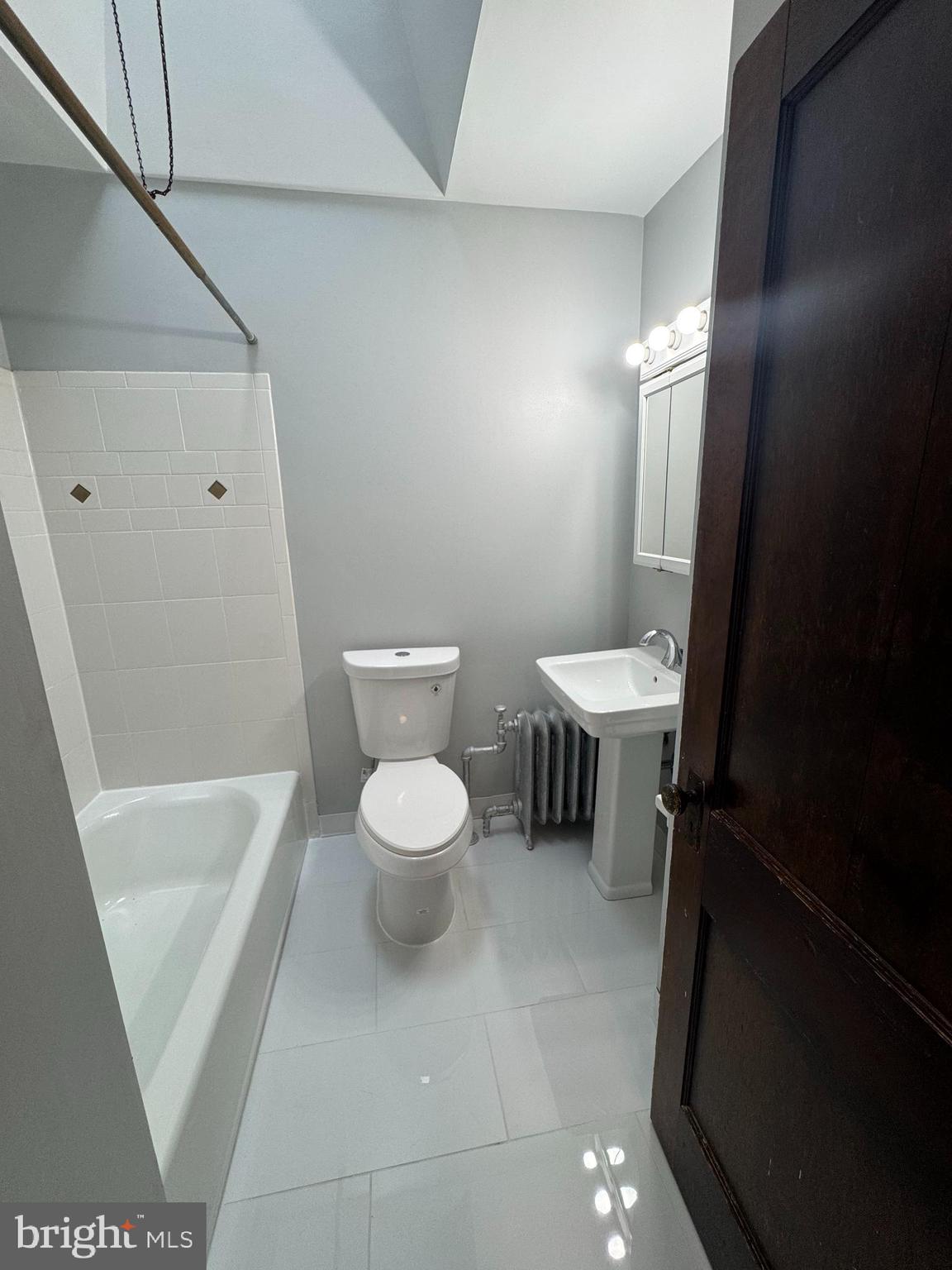 12 West Athens Avenue Ardmore, PA 19003 - Photo 9 of 18 a white toilet sitting next to a white tub