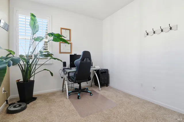a backyard of a house with table and chairs