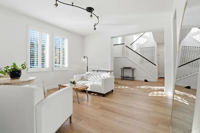 a living room with furniture and wooden floor