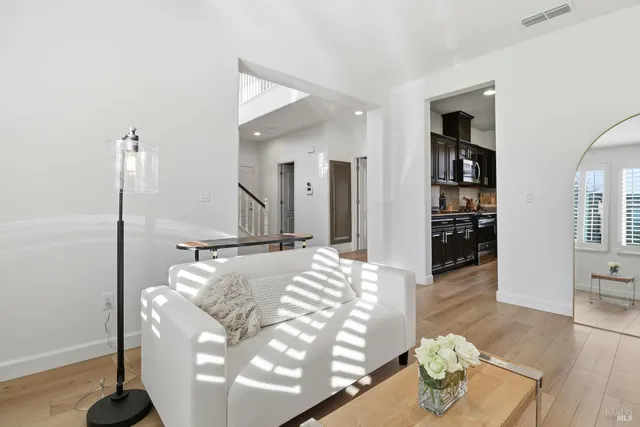 a living room with furniture kitchen and a table
