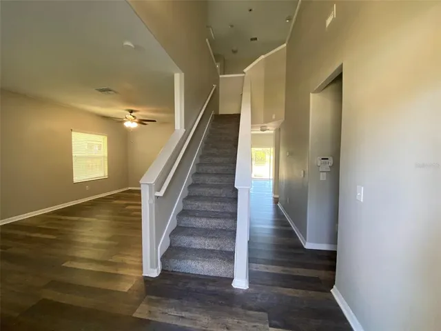 a view of entryway and hall with wooden floor