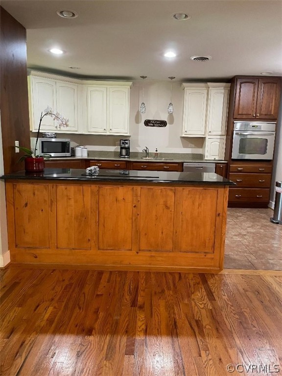 9201 Winterpock Road Chesterfield, VA 23832 - Photo 14 of 28 a kitchen with granite countertop wooden floors stainless steel appliances and cabinets