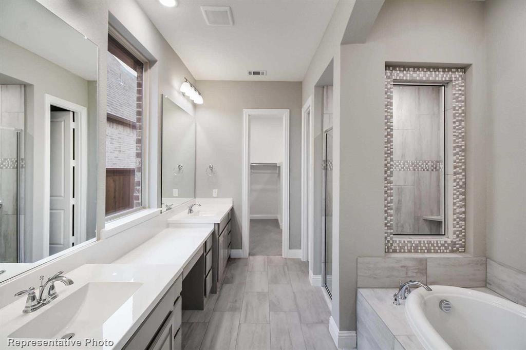 a spacious bathroom with a tub shower and sink