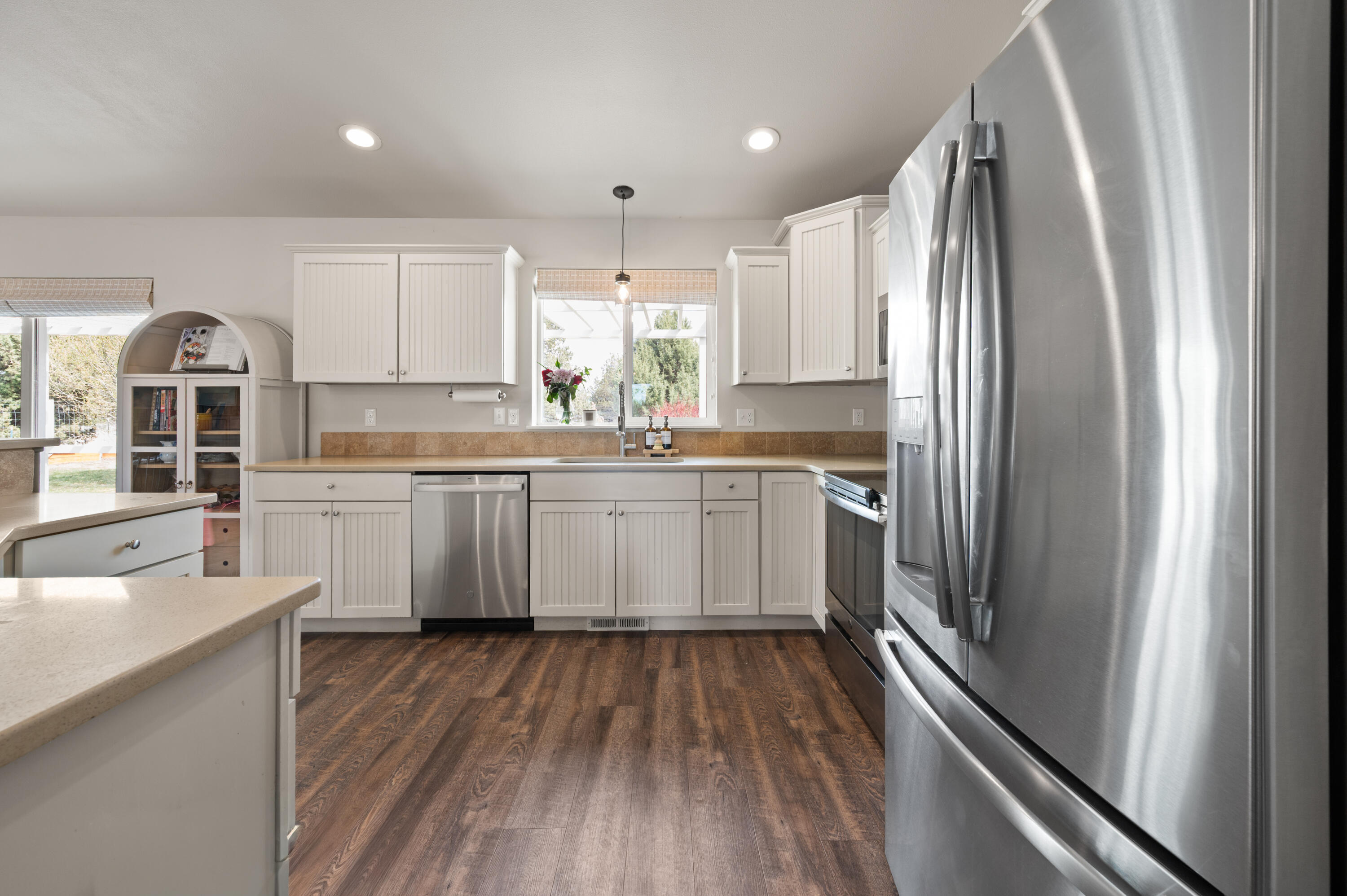 16625 Southwest Dove Road Terrebonne, OR 97760 - Photo 20 of 50 a kitchen with a sink wooden floor and stainless steel appliances