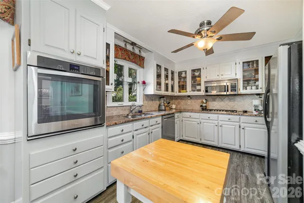 a kitchen with stainless steel appliances granite countertop a stove and a sink