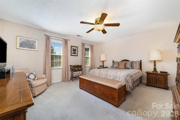 a spacious bedroom with a bed and furniture