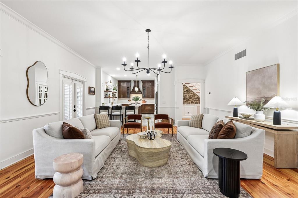 1012 Morfield Lane Brandon, FL 33511 - Photo 29 of 100 a living room with furniture a chandelier and a fireplace