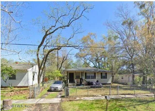 a front view of a house with swimming pool and chairs