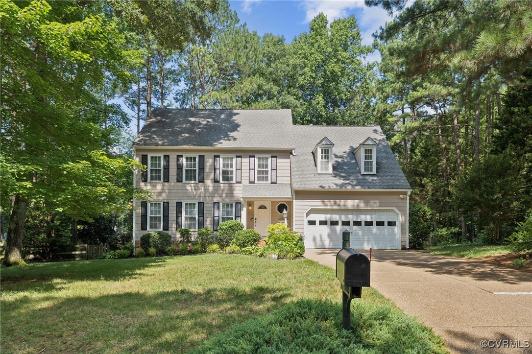 a view of a big house with a big yard and large trees