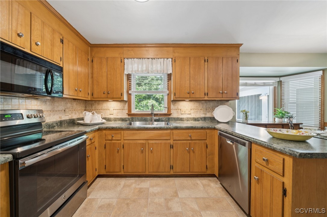 3000 Cove Ridge Road Midlothian, VA 23112 - Photo 15 of 47 a kitchen with stainless steel appliances granite countertop wooden cabinets a sink and dishwasher a stove top oven with wooden floor