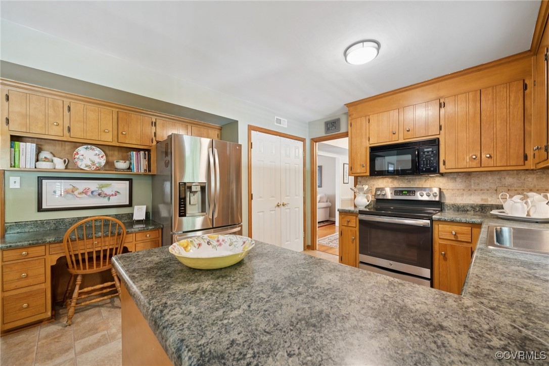 3000 Cove Ridge Road Midlothian, VA 23112 - Photo 17 of 47 a large kitchen with stainless steel appliances granite countertop a stove top oven a sink dishwasher a dining table and chairs with wooden floor
