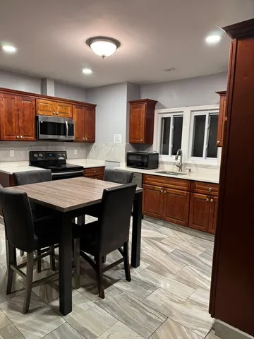 a kitchen with a sink cabinets and stainless steel appliances