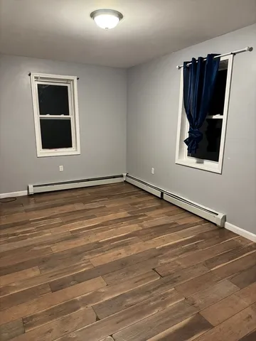 a view of a livingroom with wooden floor and a ceiling fan