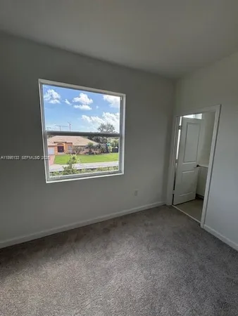 a view of an empty room and a window