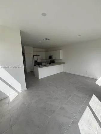 a kitchen with stainless steel appliances a refrigerator sink and stove