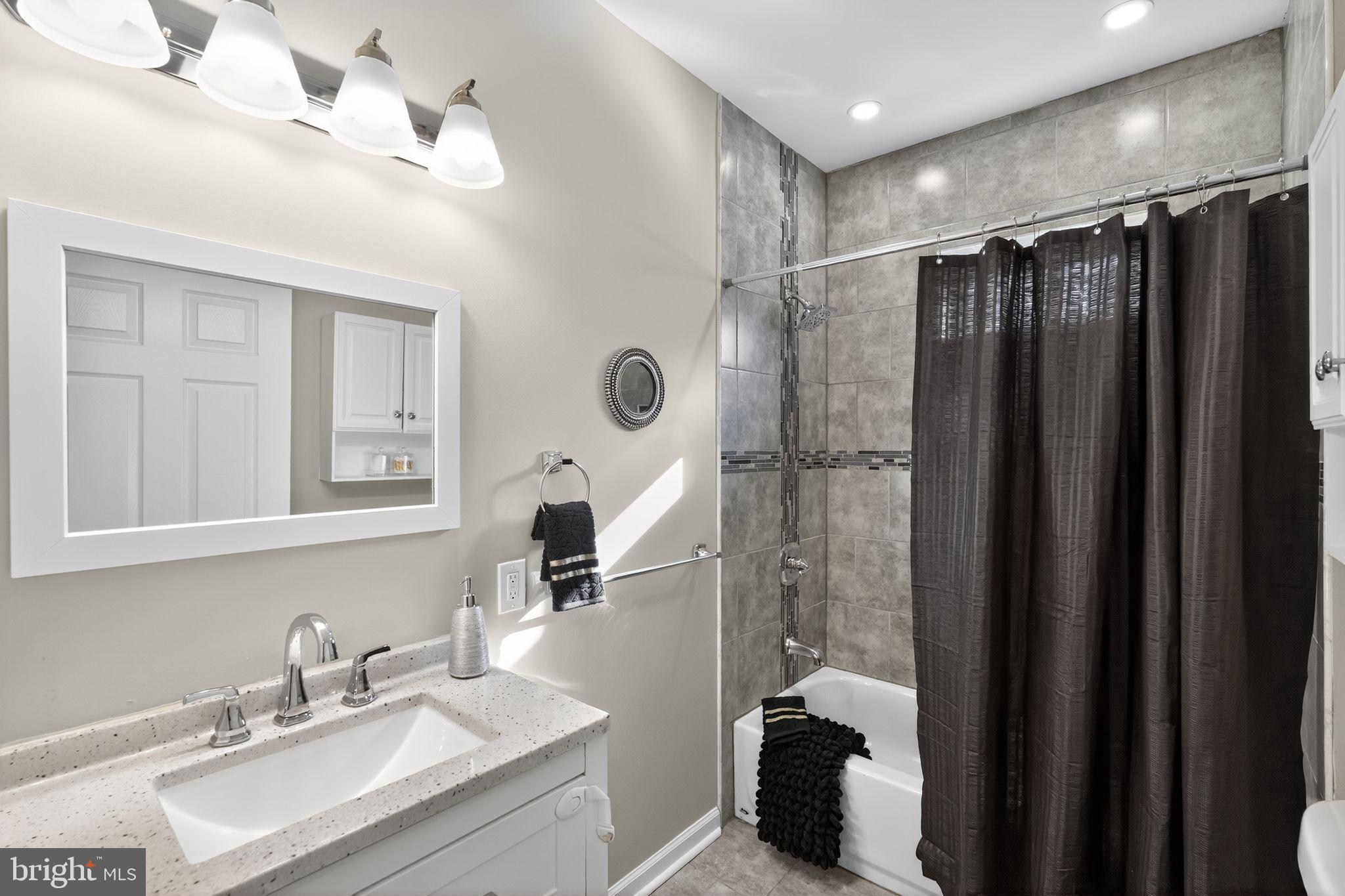 5335 Wakefield Street Philadelphia, PA 19144 - Photo 19 of 30 a bathroom with a double vanity sink toilet and shower