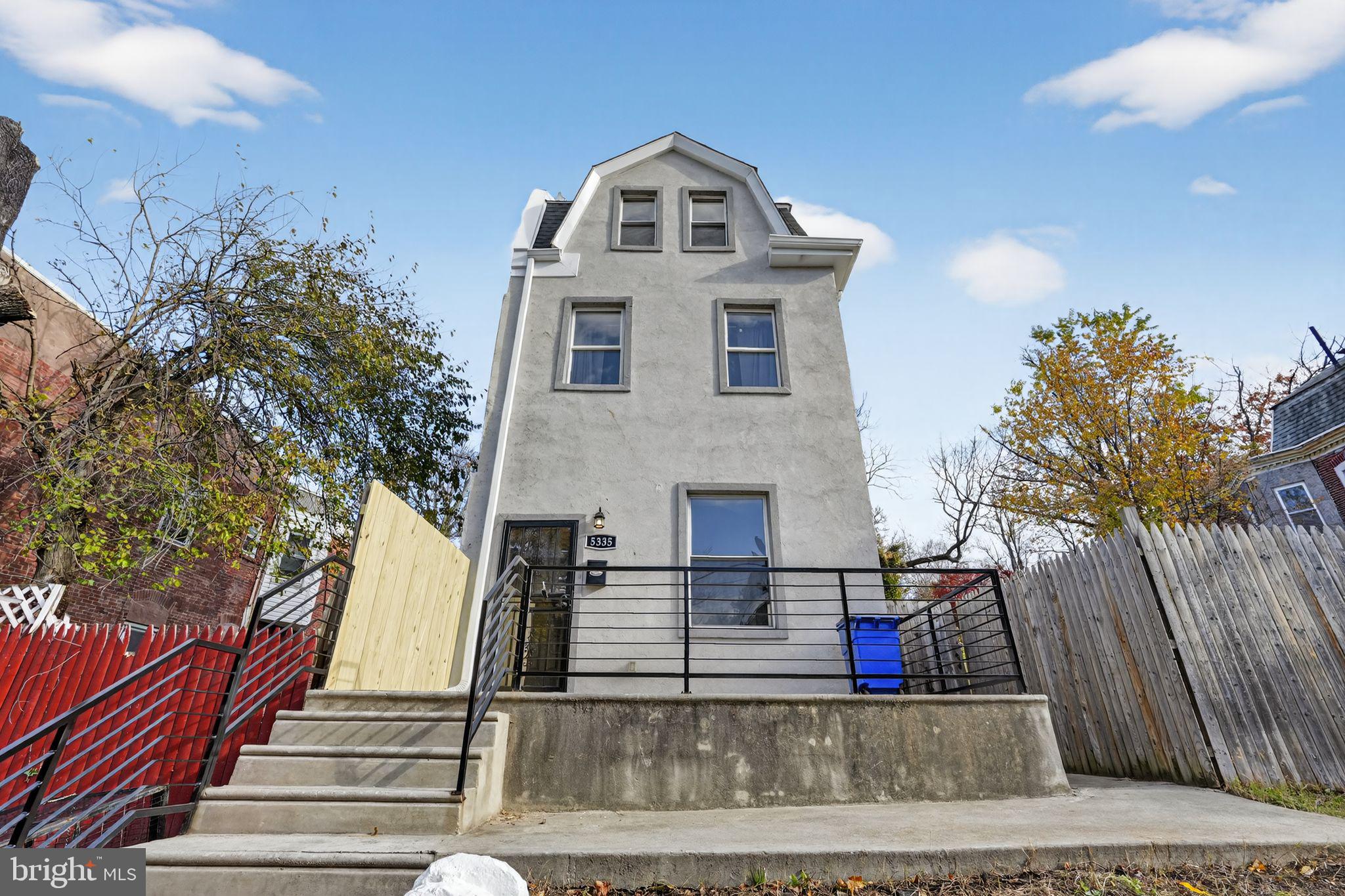 5335 Wakefield Street Philadelphia, PA 19144 - Photo 27 of 30 a view of a white house with a large tree and windows