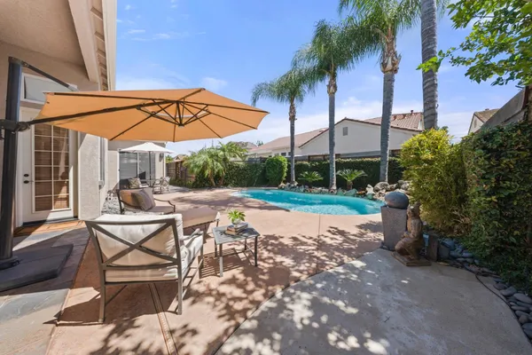 a view of a backyard with a sitting area