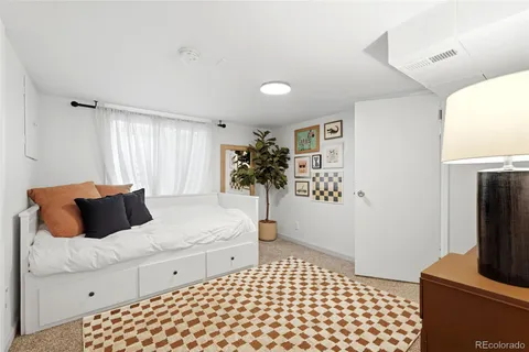 a bedroom with a bed and a potted plant