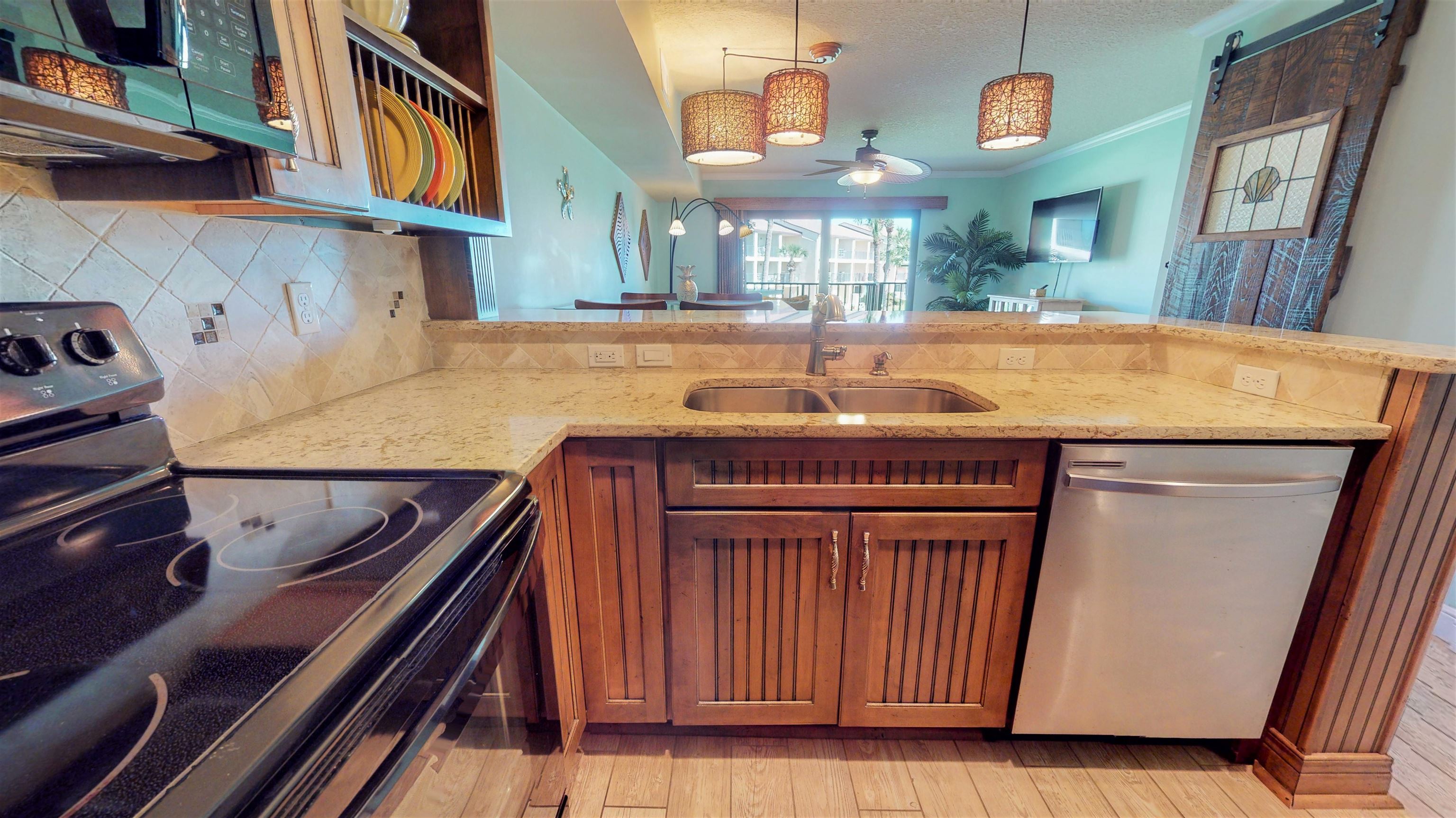 850 A1A Beach Boulevard, Unit 15 St. Augustine, FL 32080 - Photo 8 of 35 a kitchen with kitchen island a stove and a refrigerator