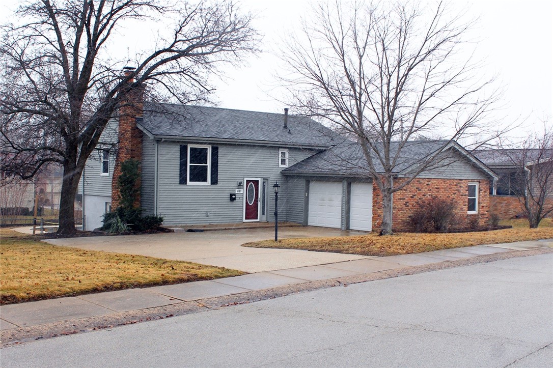 4153 Buckingham Drive Decatur, IL 62526 - Photo 1 of 34 a house that has a tree in front of it