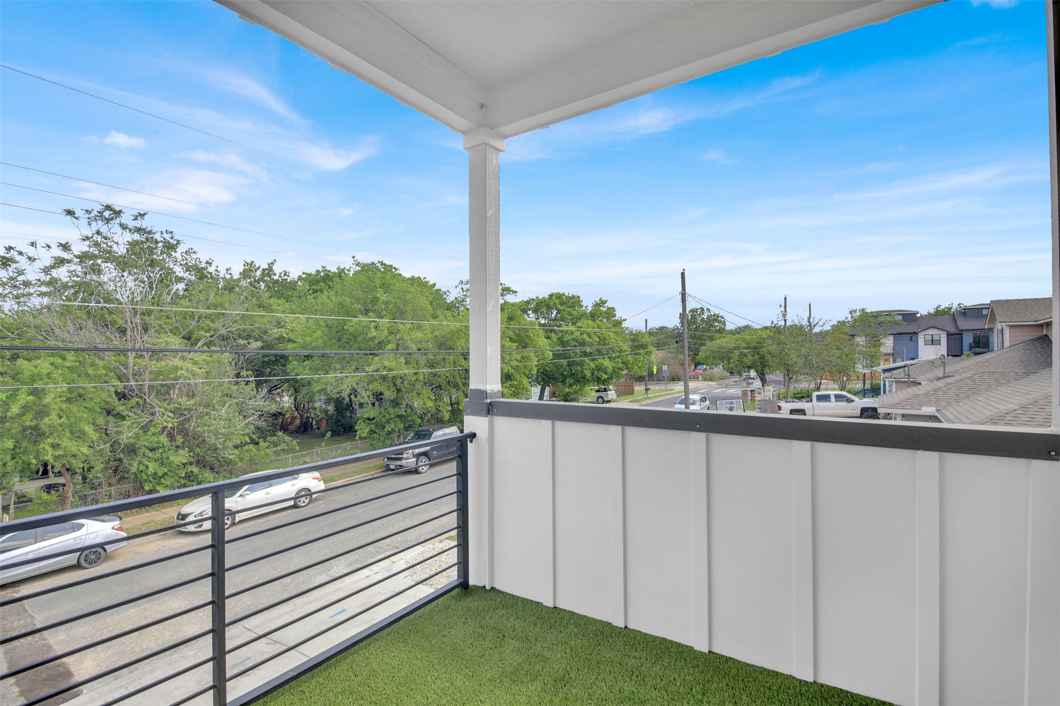 7208 Providence Avenue, Unit 1 Austin, TX 78752 - Photo 18 of 26 The property features a balcony with artificial turf flooring and a black metal railing